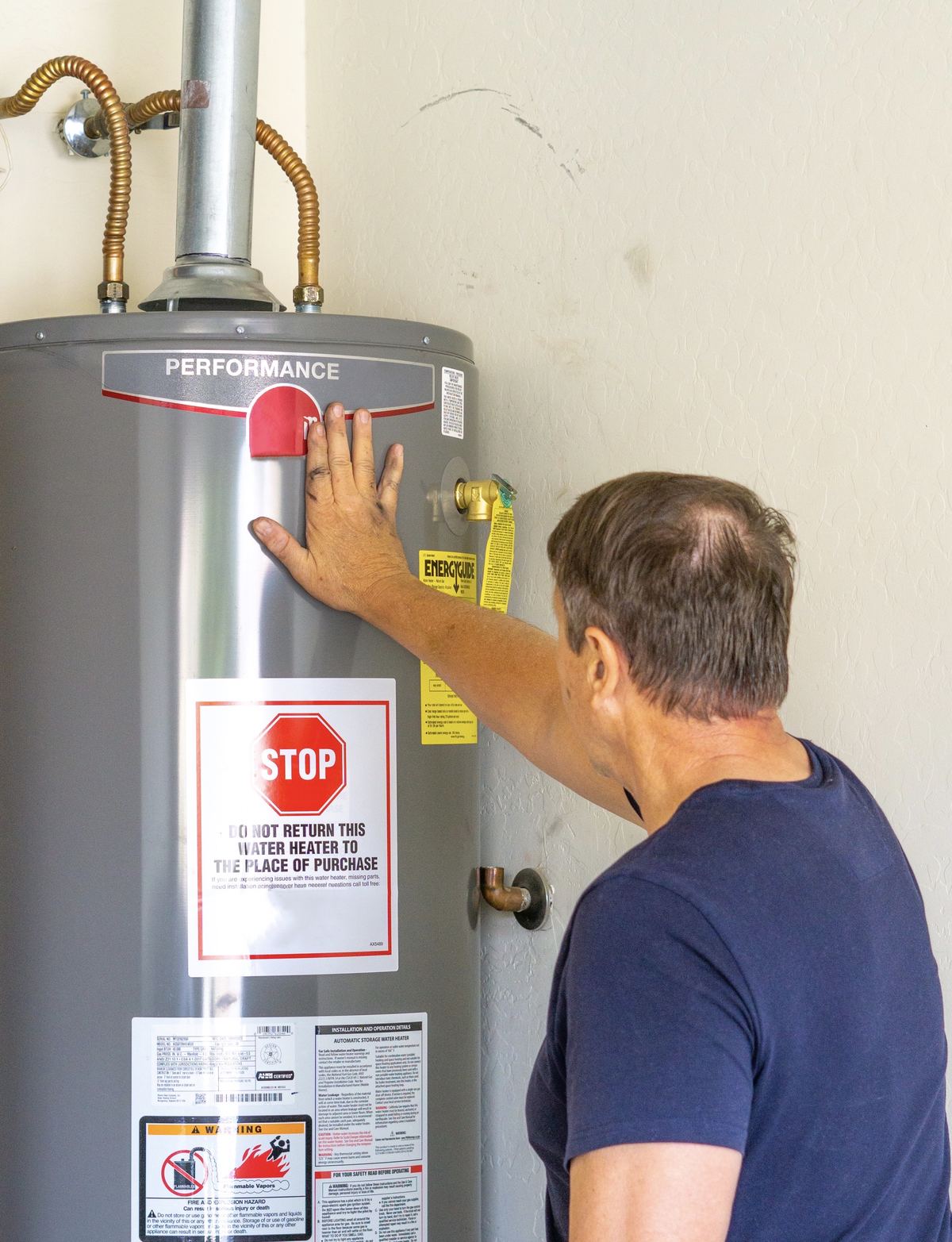 Technician installing a residential water heater